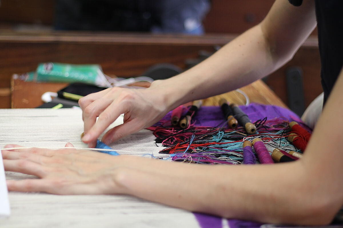 A tapestry being woven on a loom at the Maison de la Tapisserie in Aubusson