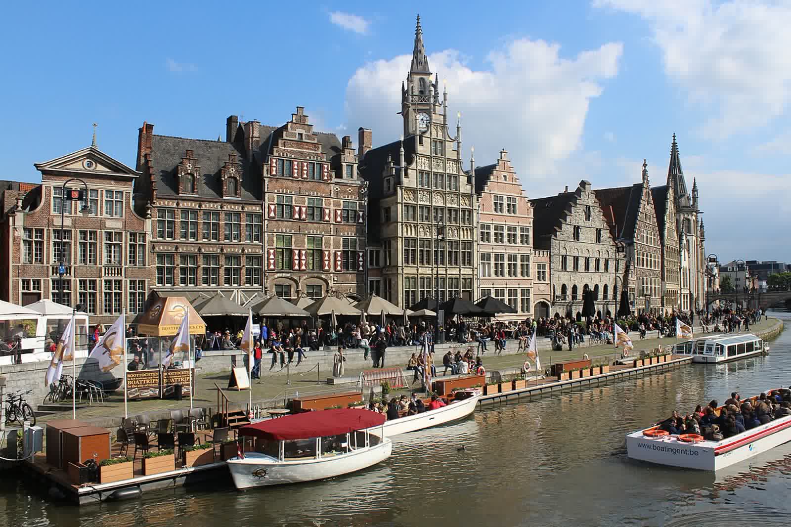 Medieval guild houses with stepped gables line the Graslei quay along the Leie river in Ghent
