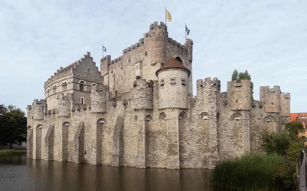 Het Gravensteen, the medieval castle of the counts, seen from the Hoofdbrug with its stone walls and moat