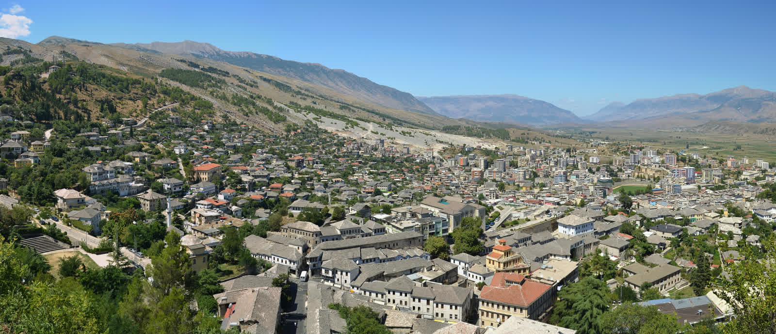 Panoramic view of Gjirokastër from the fortress, showing stone rooftops cascading down the hillside