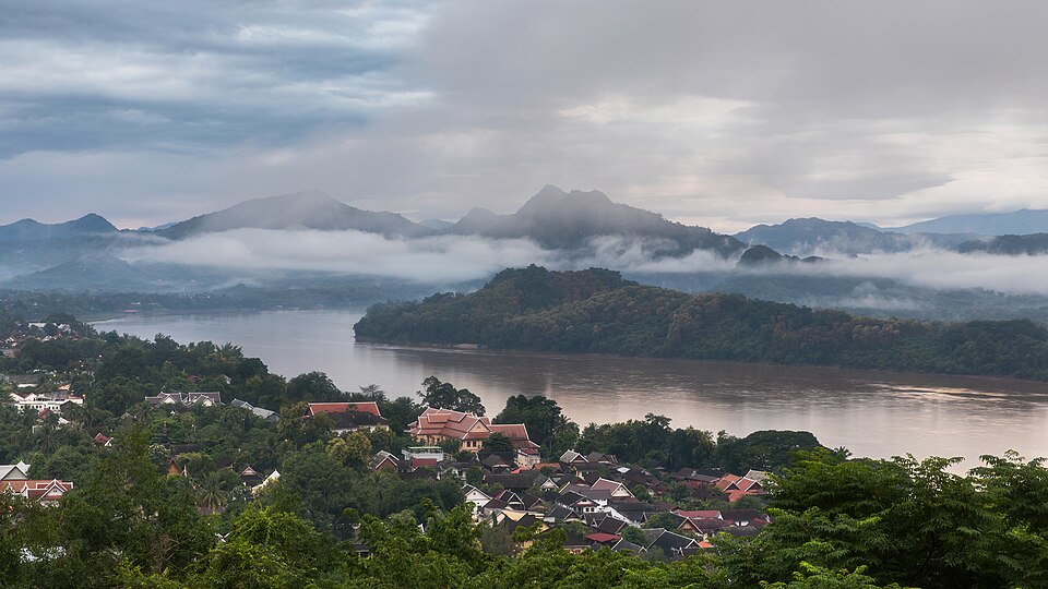 Luang Prabang seen from Mount Phousi at sunrise, with the Mekong river and misty mountains beyond