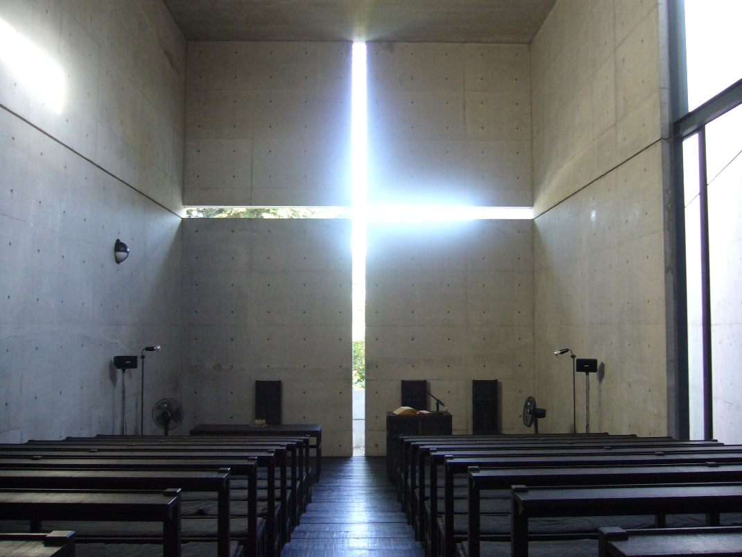 Tadao Ando's Church of the Light, Ibaraki, Osaka. A cross-shaped slit in a concrete wall lets raw sunlight into a dark room.